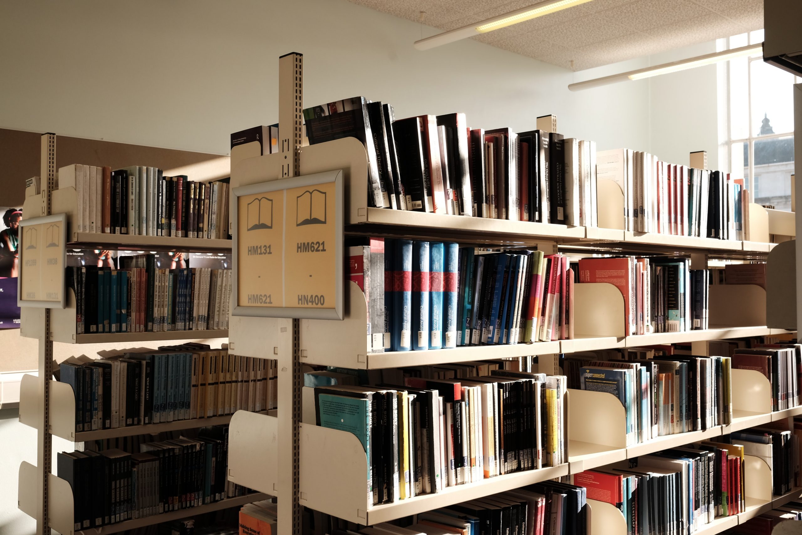 Photo by Xiaoxia Xu brown wooden book shelf with books